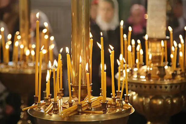 Burning yellow candles in thechurch, sacred fire