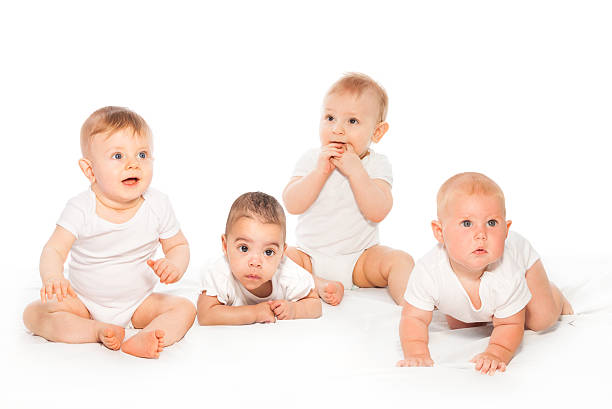 istock Curious looking group of babies on the white 475618456