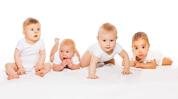 istock Cute babies crawl in a row wearing white bodysuit 475618492