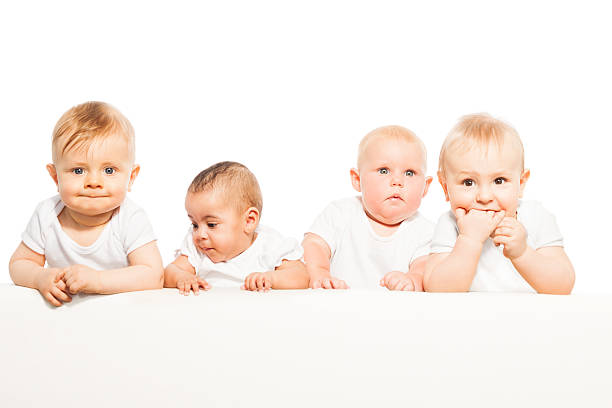 istock Four babies stand in a row on the white background 475618510