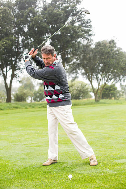 istock Golfer swinging his club on the course 475621340