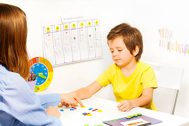 istock Boy putting colorful shaped coins in order 475621368