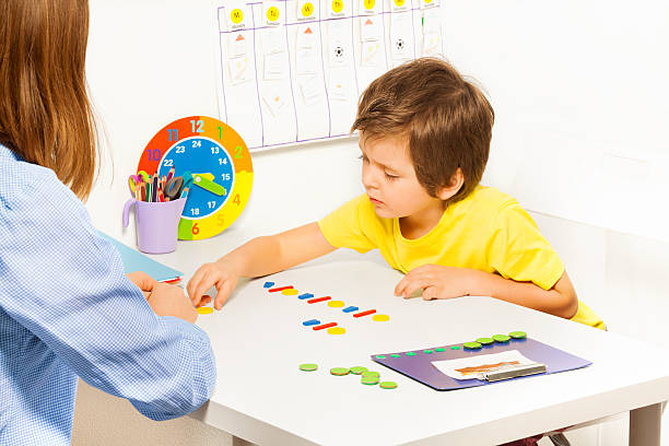 istock Concentrated boy putts colorful coins during ABA 475621380