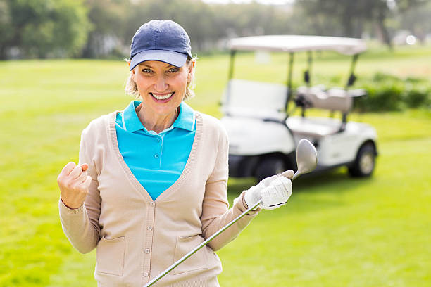 istock Female golfer smiling at camera 475623594