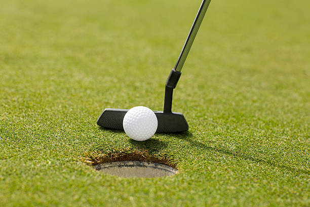 istock Golf club putting ball at the hole 475623658