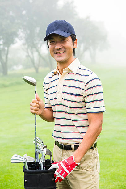 istock Happy golfer taking club from golf bag 475623790