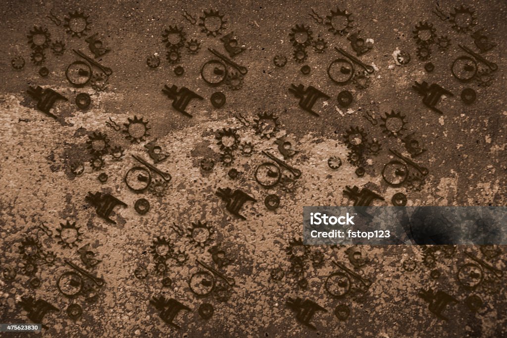 Backgrounds. Wallpaper pattern of gears, machine parts on grunge. Background. Wallpaper pattern of many mechanical pieces of hardware and gears lying on a grunge background.  Monochromatic color scheme of grays and tans.  Mud colored. Unique abstract background.  2015 Stock Photo