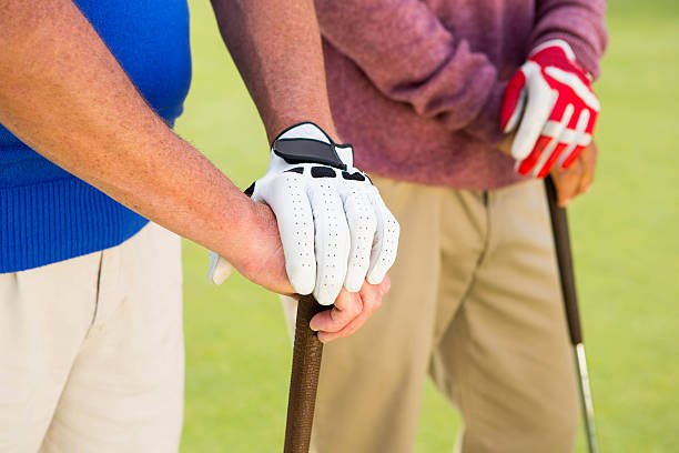 istock Golfing friends standing and holding clubs 475626202