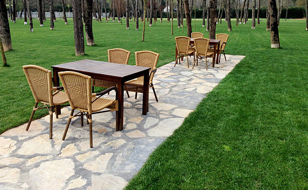istock Dining tables, trees and lawn in garden 475626688
