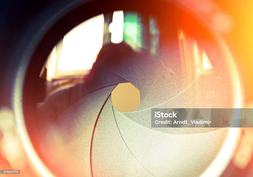 The diaphragm of a camera lens. The diaphragm of a camera lens aperture. Selective focus with shallow depth of field. Color toned image. Home Video Camera Stock Photo