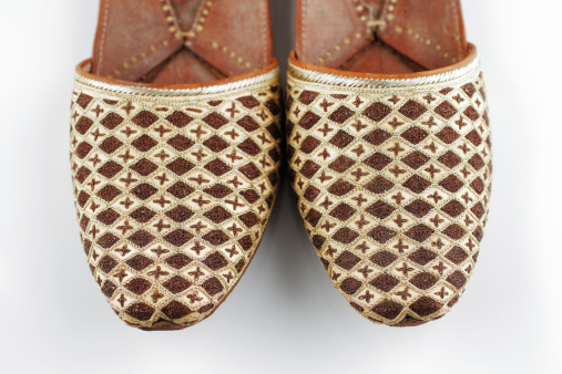 Traditional Arabic slippers shot against a white background
