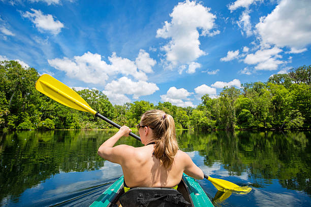 istock Woman Kayaking down a beautiful tropical jungle river 475630030