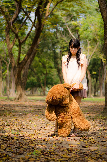 Toy people resting on her owner in city