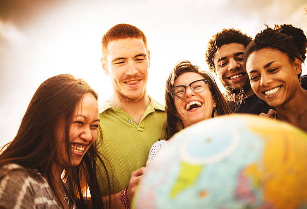 teenagers college student smiling with globe teenagers college student smiling with globe multi ethnic group college student group of people global communications stock pictures, royalty-free photos & images