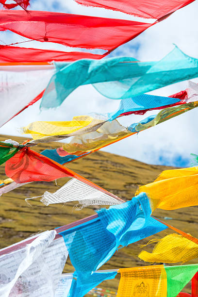 Tibetan prayer flags on a mountain pass in Tibet. A prayer flag is a colorful rectangular cloth, often found strung along mountain ridges, passes and peaks high in the Himalayas. They are used to bless the surrounding countryside and for other purposes.