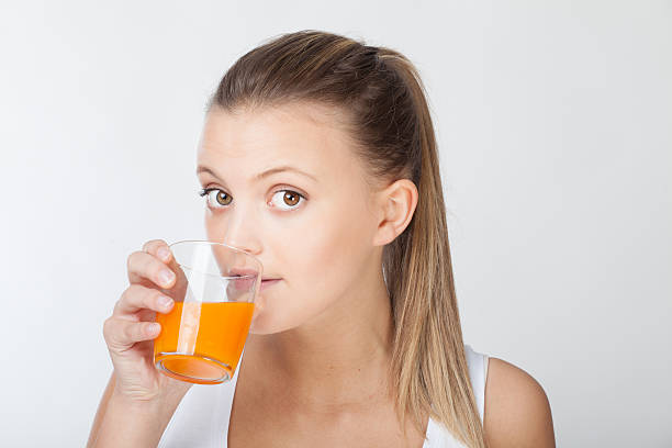 istock Woman drinking juice 475639927
