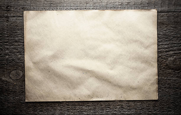 istock paper on wooden background 475642221