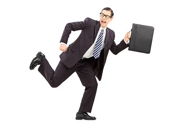 Photo of Scared male businessman running away from something