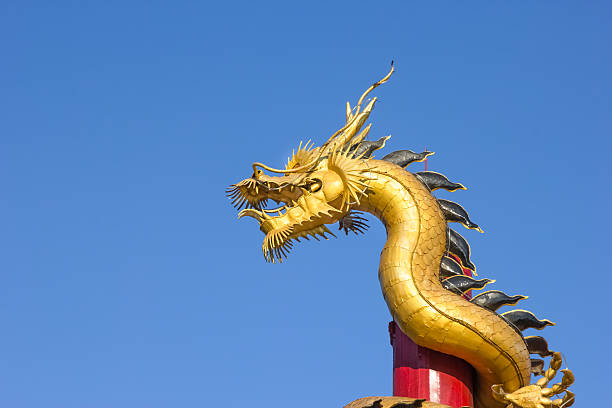 istock gold dragon on pole in Thailand 475642654