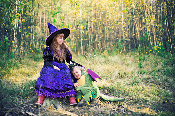 istock Happy little witch and pet her dragon. 475643028