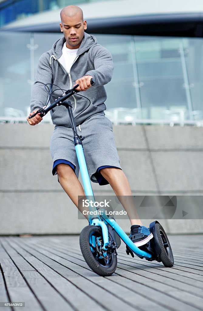 Young black male using outdoor fitness device Young black male using outdoor fitness device  2015 Stock Photo