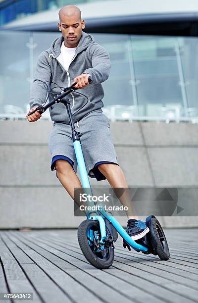 Young Black Male Using Outdoor Fitness Device Stock Photo - Download Image Now - 2015, Activity, Adult