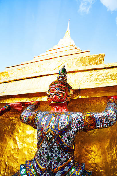 istock Golden pagoda with red Thai warrior statue 475645770