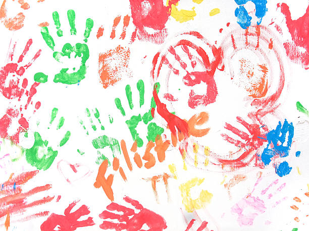 istock finger painted white wall with color palms 475645846