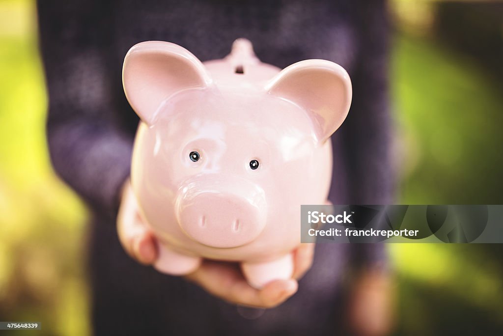 holding the piggy bank - family savings Coin Bank Stock Photo