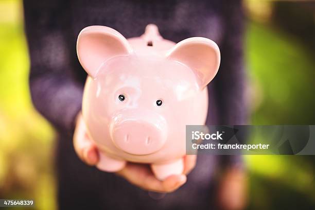 Holding The Piggy Bank Family Savings Stock Photo - Download Image Now - Coin Bank, Concepts, Concepts & Topics