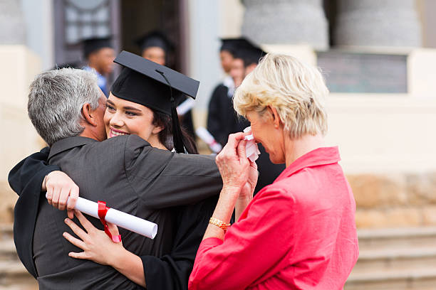 istock young female graduate hugging her father 475648529