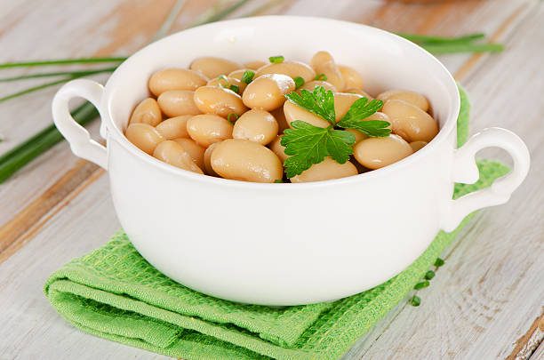 istock Beans  with  herbs  on a  wooden table . 475650888