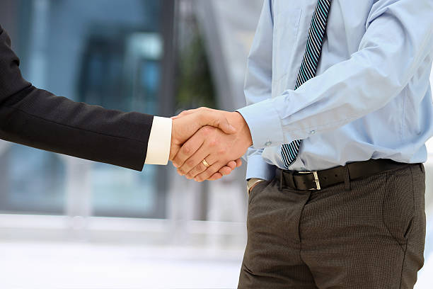 istock Image of a firm handshake  between two colleagues in office 475650974