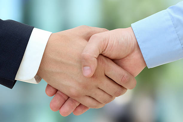 istock Image of a firm handshake  between two colleagues in office 475651056