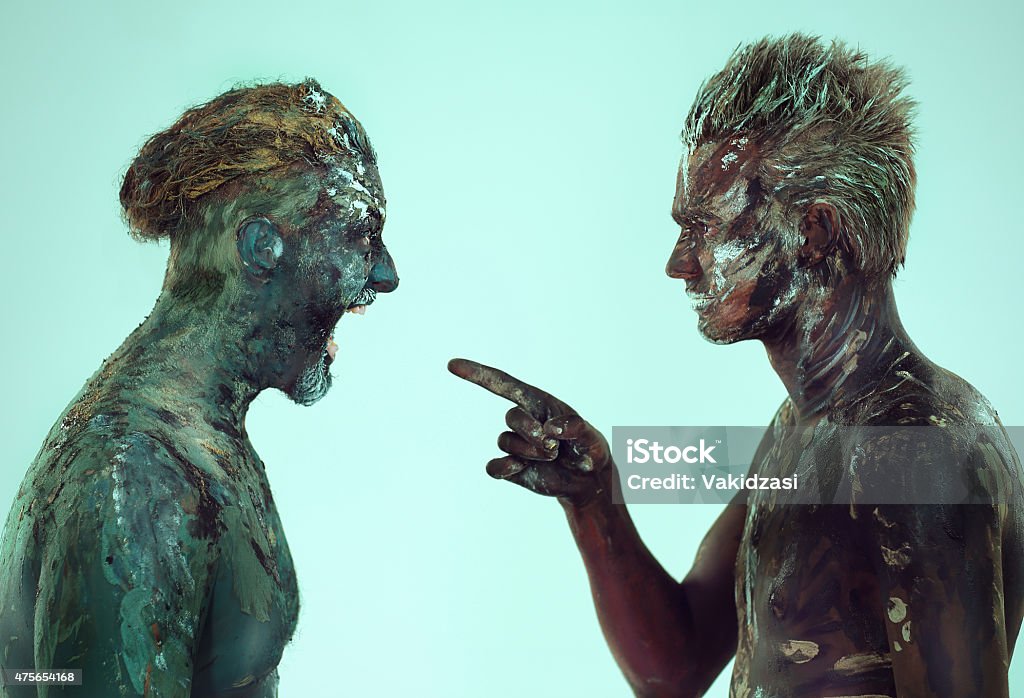 two mens expressive portrait two men expressive portrait screaming at each other in body art painted,in the studio on a green background   2015 Stock Photo