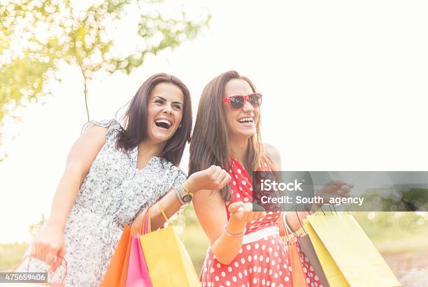 Two Smiling Teenage Girls With Shopping Bags Stock Photo - Download Image Now - 2015, Adult, Bag