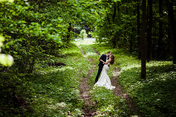 istock Bride and groom are kissing on a footpath 475660240