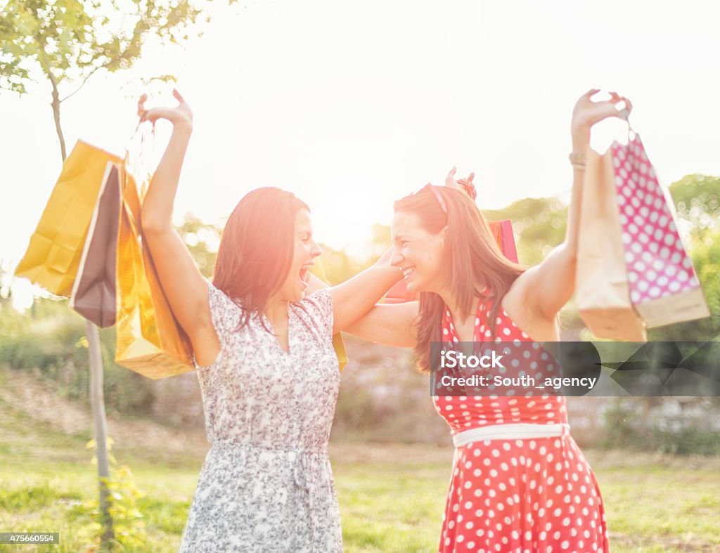 two smiling teenage girls with shopping bags shopping, sale and gifts concept - two smiling teenage girls with shopping bagsshopping, sale and gifts concept - two smiling teenage girls with shopping bags 2015 Stock Photo