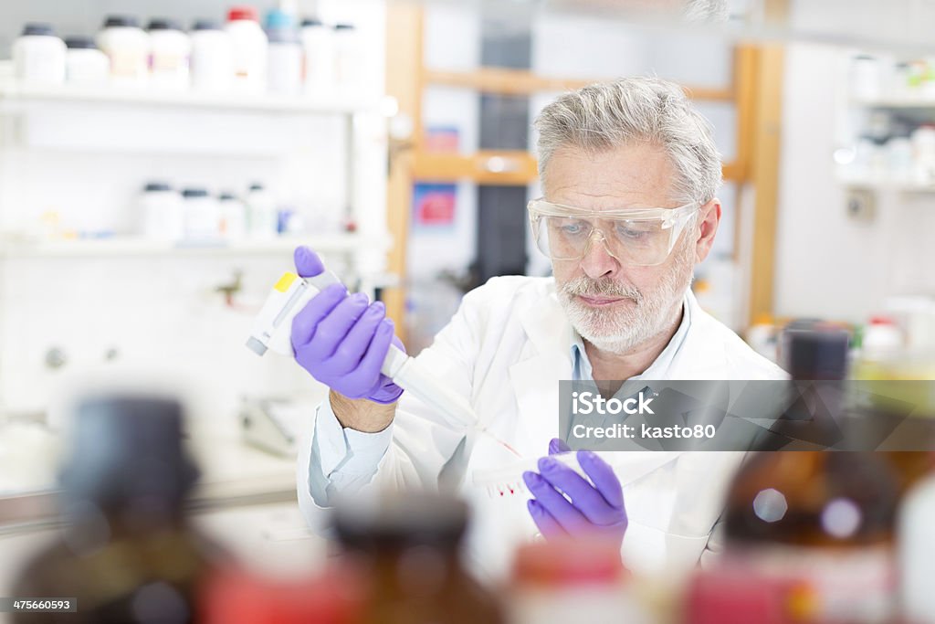 Life scientist researching in the laboratory. Life scientist researching in laboratory. Life sciences comprise fields of science that involve the scientific study of living organisms: microorganism, plant, animal and human cells, genes, DNA... Adult Stock Photo