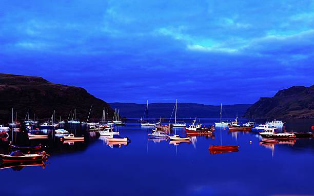 Portee Harbour at Night Duning Summer Vie of Portree Harbour at night during summer. Many boats at anchor portee isle of skye stock pictures, royalty-free photos & images