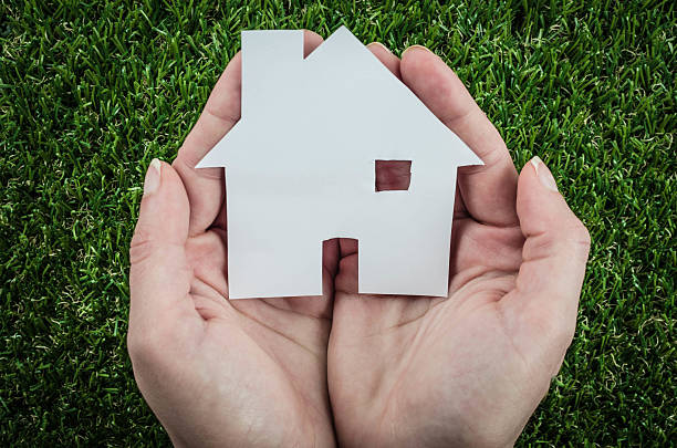 istock Holding a small paper house with a chimney 475661012