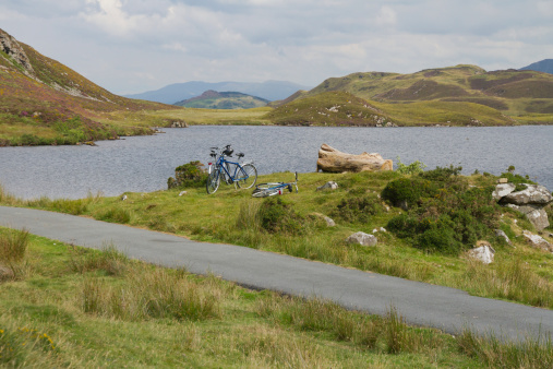 Bikes by Llyyyau Cregennen beneath Cader idris a mountain in Gwynedd, Wales, which lies at the southern end of the Snowdonia National Park near the town of Dolgellau, UK.