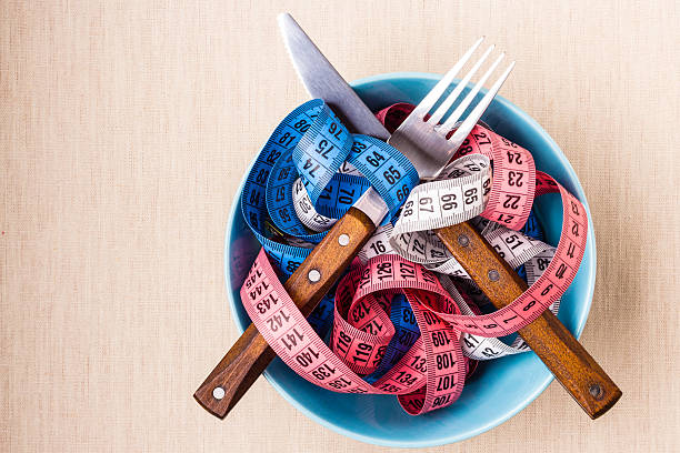 istock Many colorful measuring tapes in bowl on table 475666410