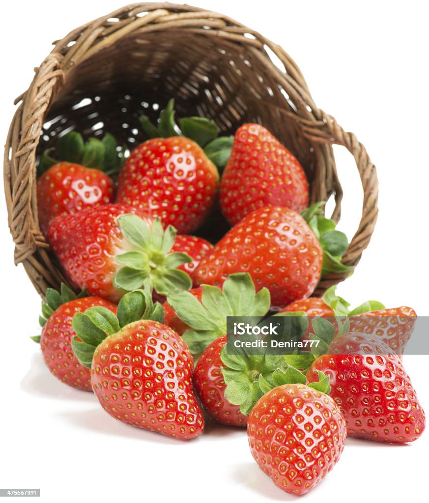 strawberry underlying basket with strawberries spilling on a white Basket Stock Photo