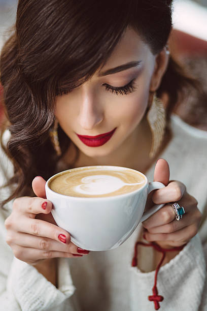istock Young girl drinking coffee in a trendy cafe 475667843