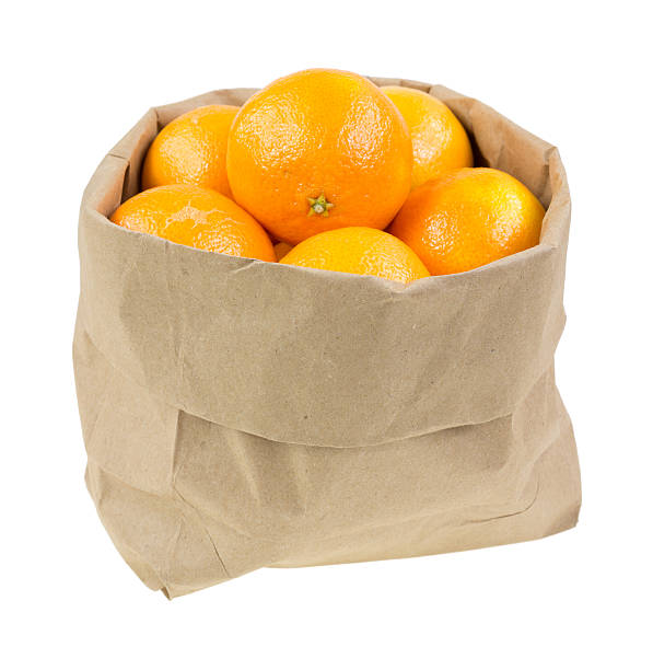 istock Paper bag filled with small oranges 475667927