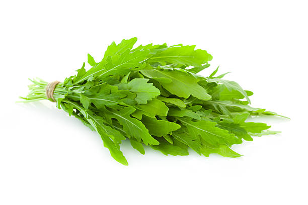 istock Bunch of fresh Ruccola  leaves /  rocket salad   isolated 475667935