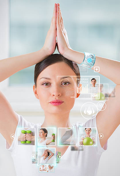 istock Woman doing exercise wearing smart wearable device with futurist interface 475669048