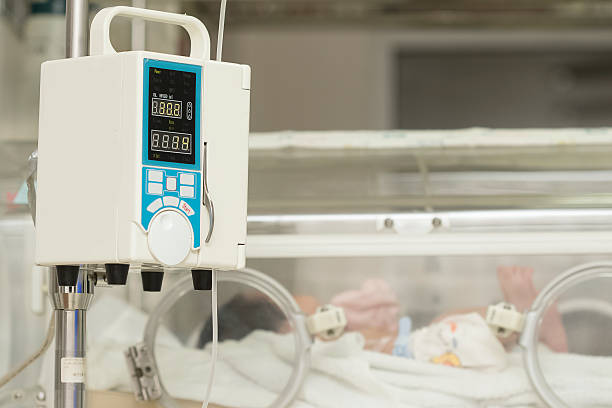 istock Infusion pump feeding IV drip into baby's patients 475669280