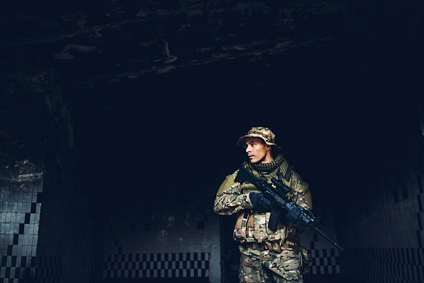 istock soldier with rifle in the ruins 475672790